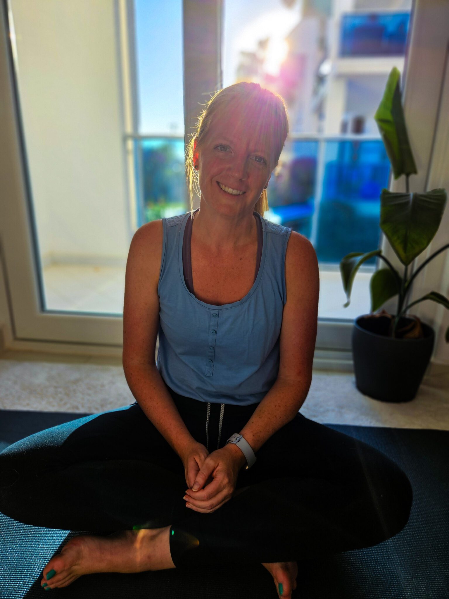 Nathalie, yoga teacher at Yoga Nisarga, seated and smiling