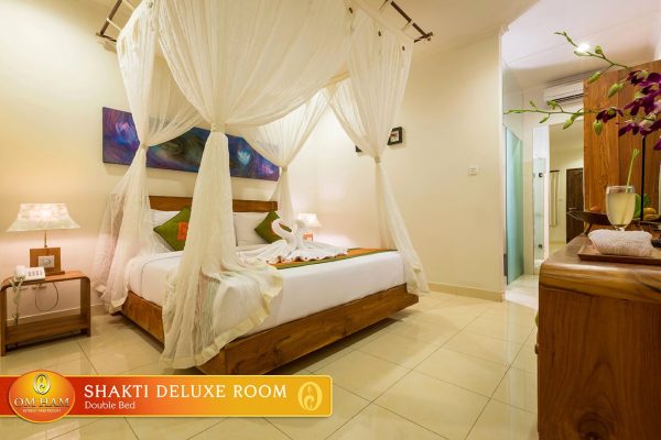 Shakti Deluxe room at the Bali yoga retreat venue in Ubud, canopied double bed