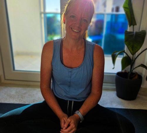 Nathalie, yoga teacher at Yoga Nisarga, seated and smiling