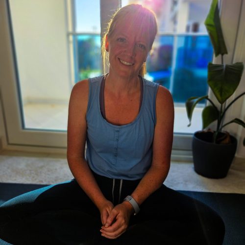 Nathalie, yoga teacher at Yoga Nisarga, seated and smiling